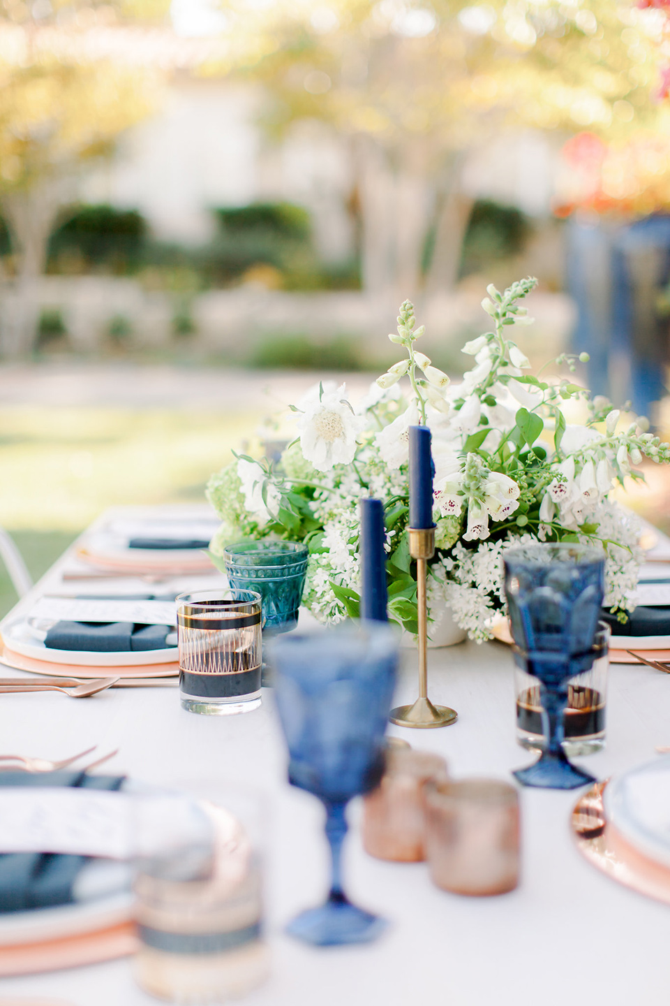  blue and blush flatware on a white reception table